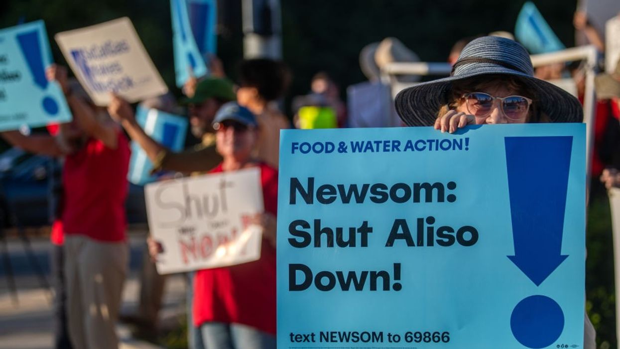 Signs says "Newsom: Shut Aliso Down"