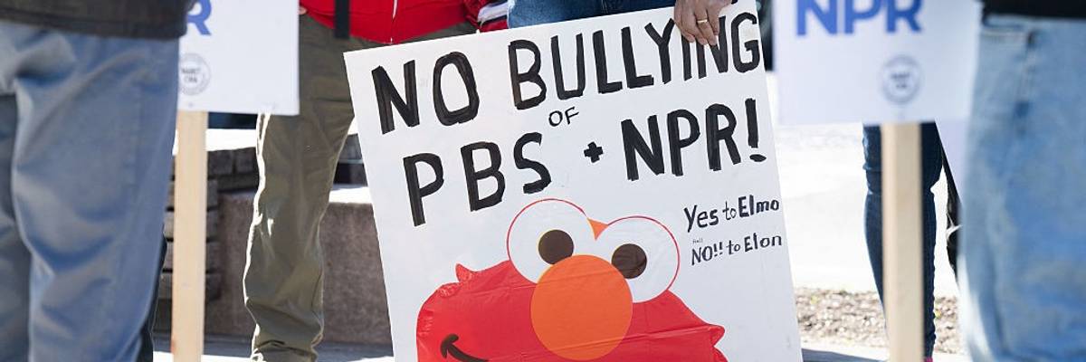 Signs says "No Bullying of PBS + NPR"