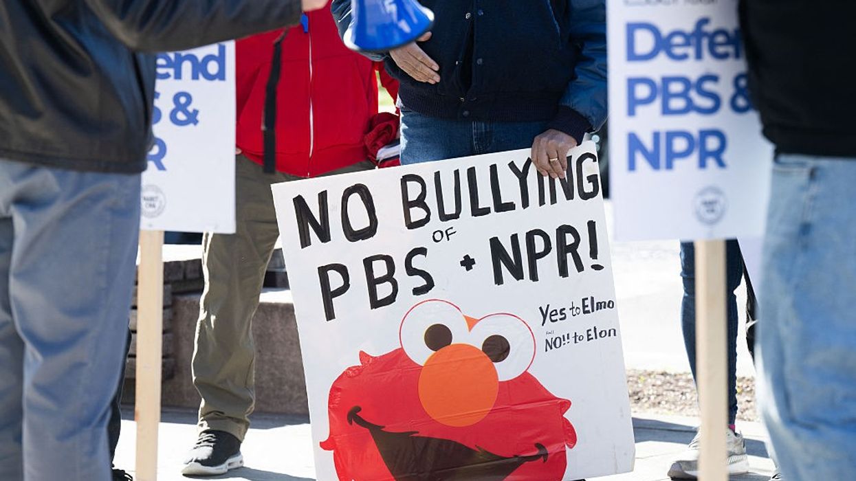 Signs says "No Bullying of PBS + NPR"