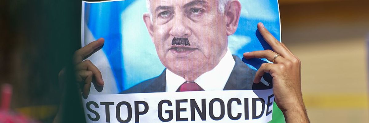 Signs says "Stop Genocide"