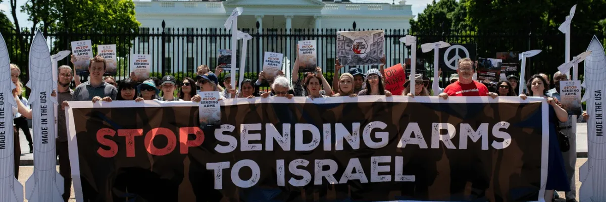 Signs says "Stop Sending Arms to Israel"
