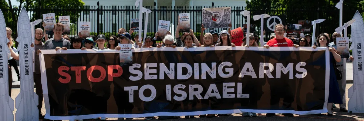 Signs says "Stop Sending Arms to Israel"