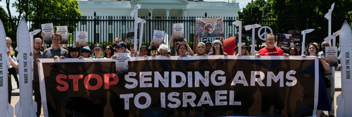 Signs says "Stop Sending Arms to Israel"