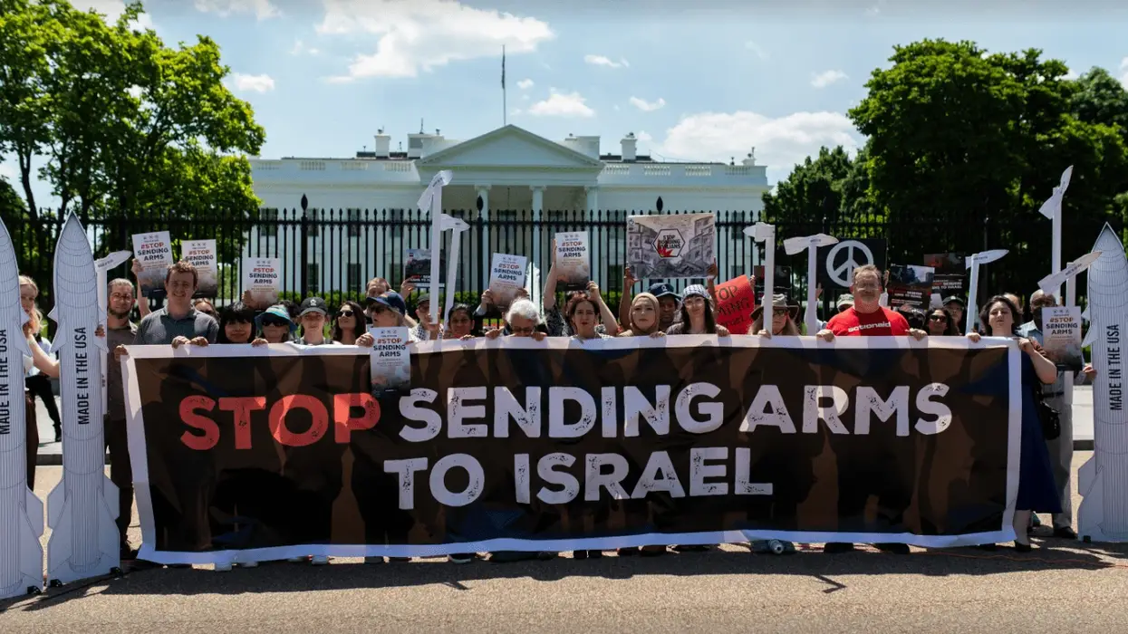 Signs says "Stop Sending Arms to Israel"
