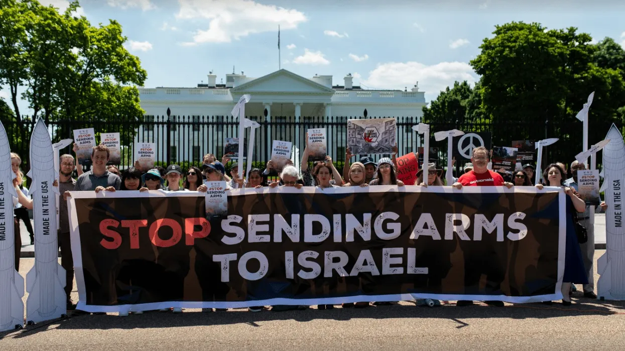 Signs says "Stop Sending Arms to Israel"