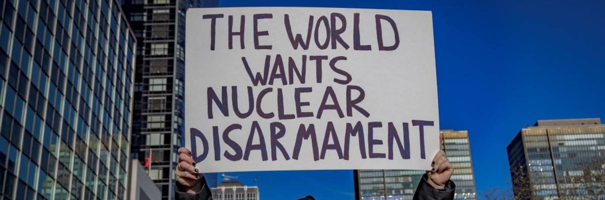 Signs says "The World Wants Nuclear Disarmament"