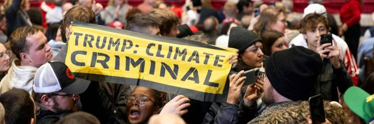 Signs says "Trump: Climate Criminal"