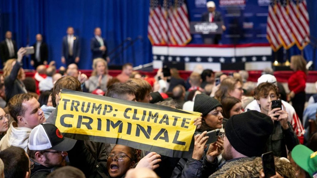 Signs says "Trump: Climate Criminal"