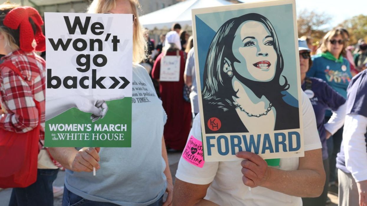 Signs says "We Won't Go Back" next to picture of Kamala Harris, which says "Forward"