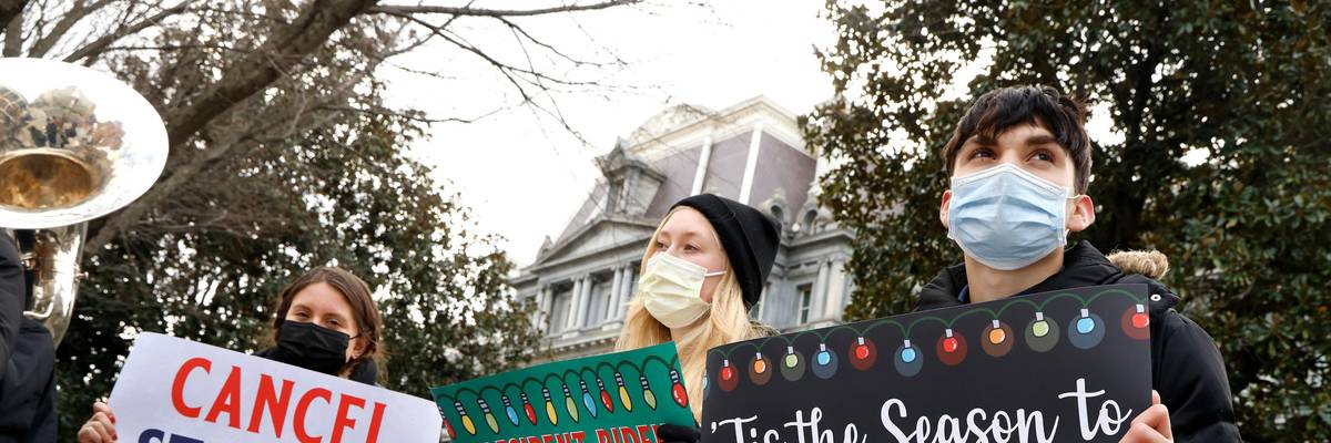 signs urging student debt forgiveness
