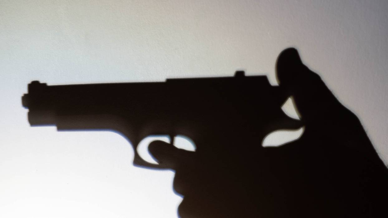 Silhouette of a person that is to shoot with a gun.