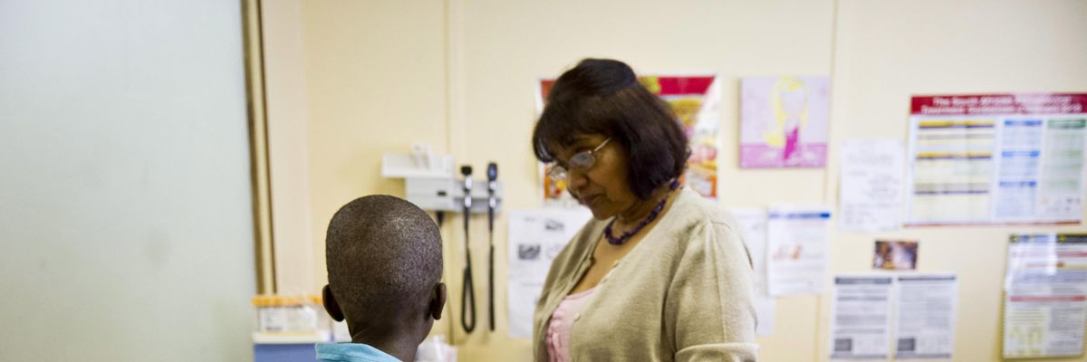 Sister Sally Naidoo administers an HIV test on a young boy