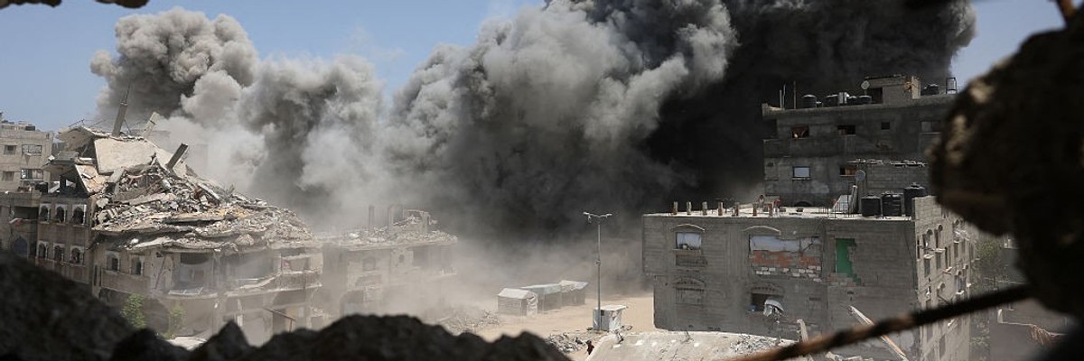 Smoke and debris rise following an Israeli strike on a house west of Jabalia