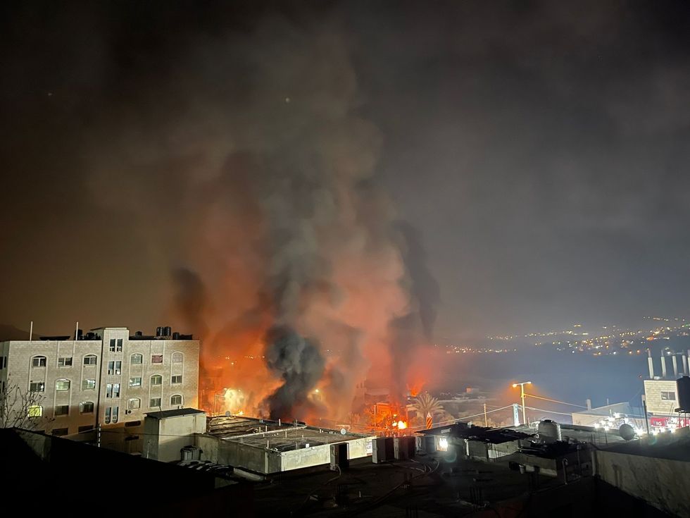  Smoke and flames rise from the West Bank town of Huwara.