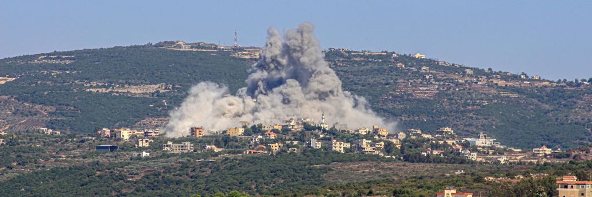smoke billowing above Lebanese village