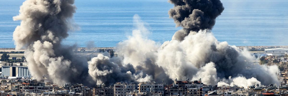 Smoke from airstrikes rises above buildings.