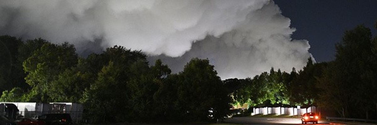 Smoke rises after a chemical fire broke out on the roof of a BioLab plant