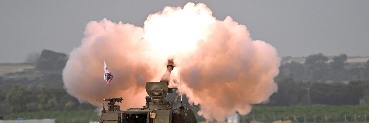 Smoke rises around Israeli artillery units and howitzers