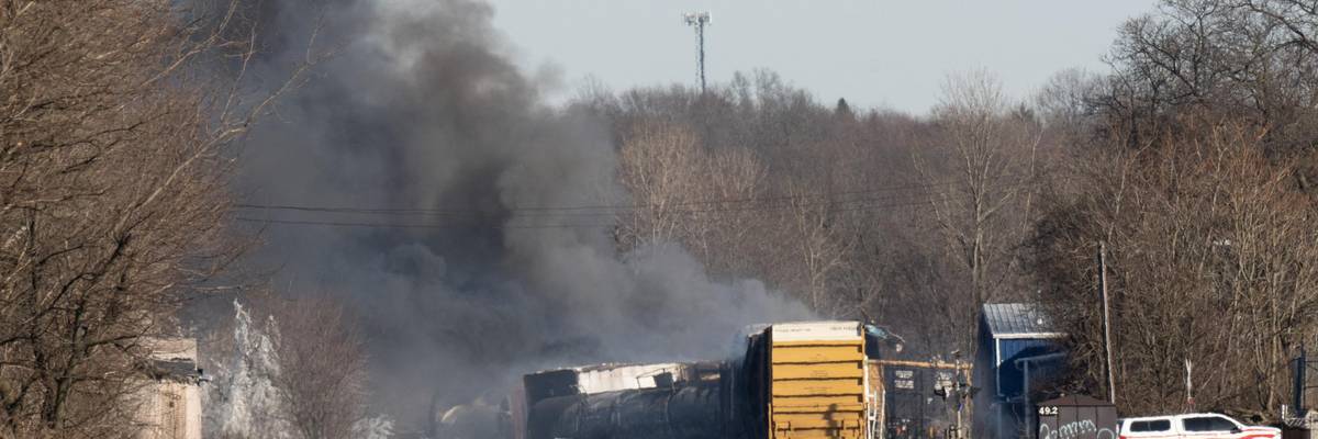 Smoke rises from a derailed cargo train