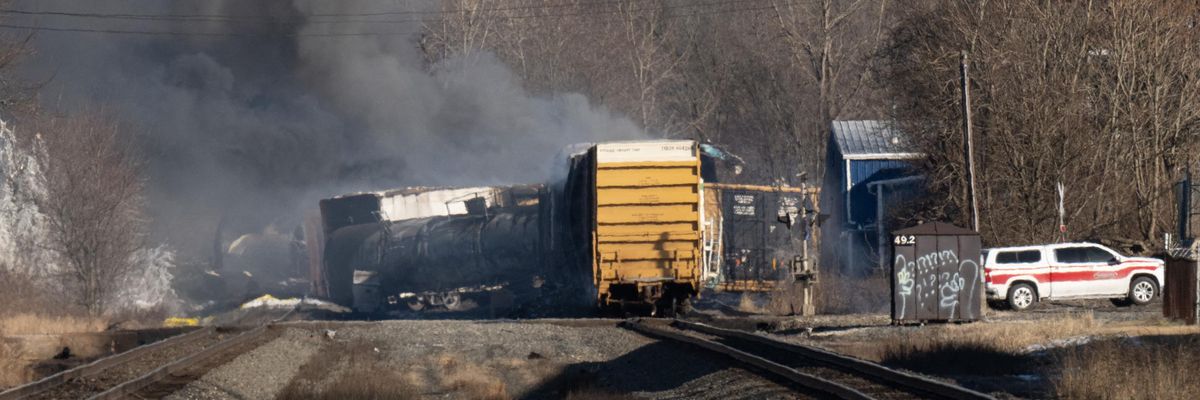 Smoke rises from a derailed cargo train