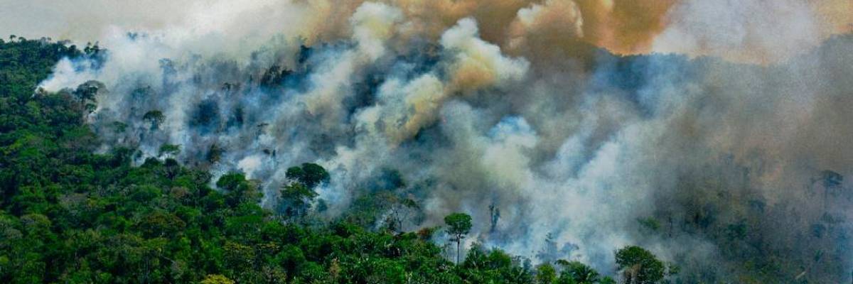 Smoke rises from the Amazon rainforest.