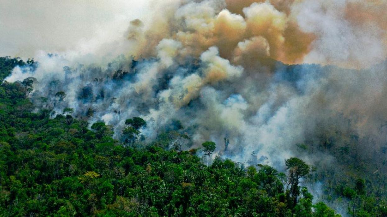 Smoke rises from the Amazon rainforest.