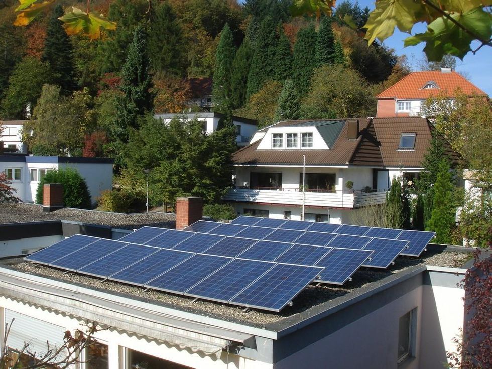 Solar panels sit atop a flat roof in Austria.  (Photo:  Steamtalks Steamtalks/flickr/cc)