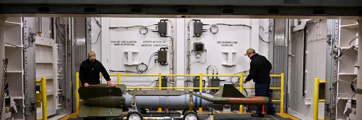 Soldiers move U.S. missile aboard aircraft carrier