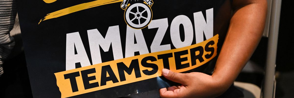 Someone holds a sign that reads "Amazon Teamsters."