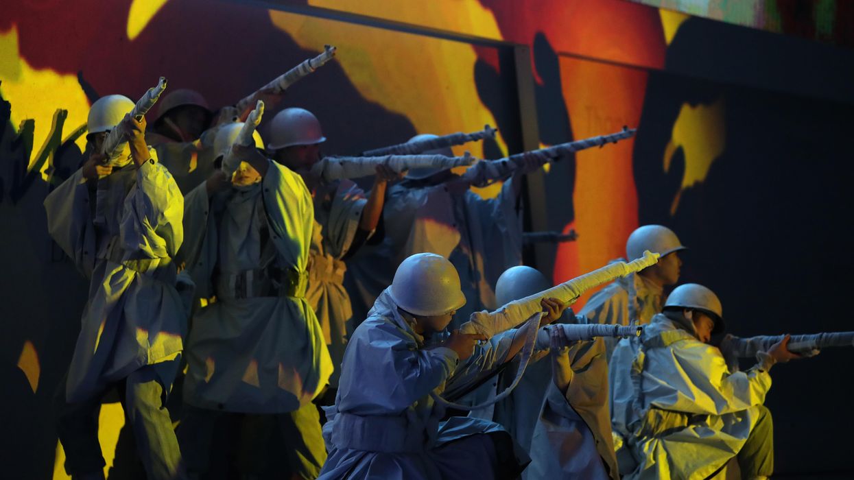South Koreans perform during a ceremony
