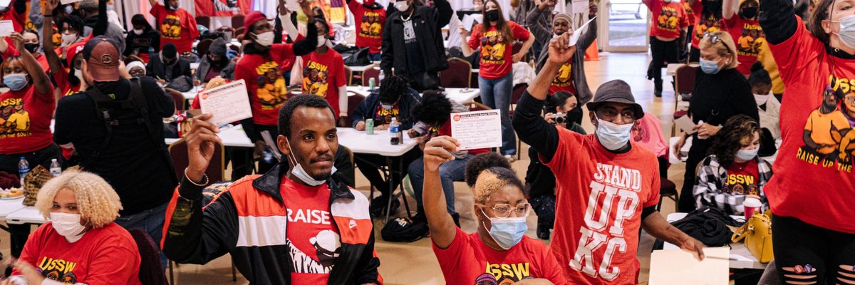 Southern service workers hold up union cards