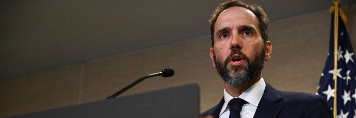 Special Counsel Jack Smith stands at a podium.