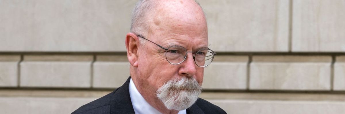 Special Counsel John Durham stands against a wall.