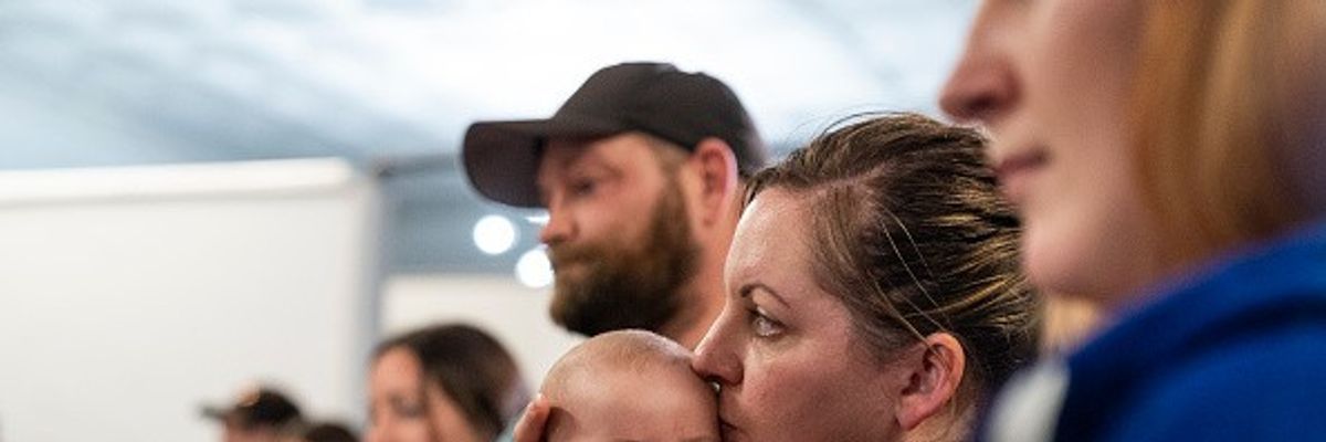 Stacey Sevacko, with baby in tow, attends a town hall meeting