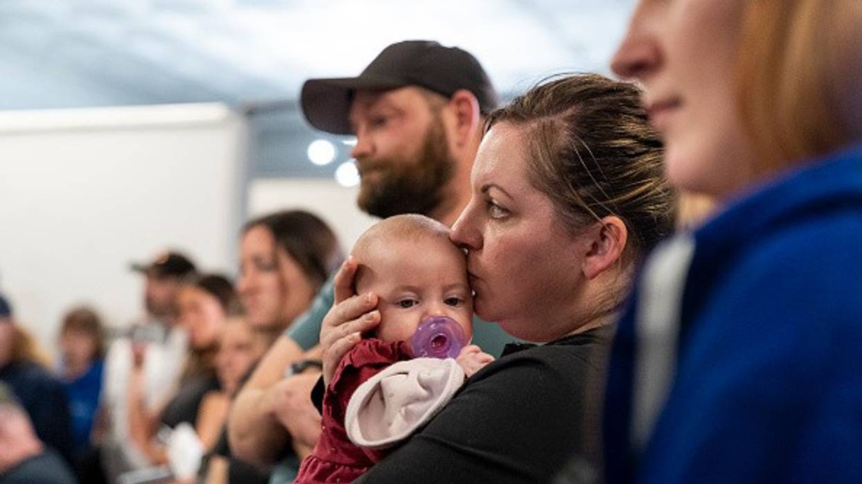 Stacey Sevacko, with baby in tow, attends a town hall meeting