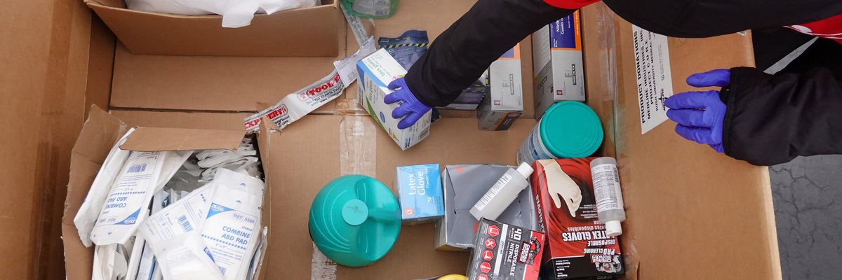 Staff and volunteers with Project C.U.R.E hold a drive outside the United Center to collect donations of personal protective equipment from the community which will be used to supply hospitals and clinics that are experiencing shortages due to the Covid-19 pandemic on March 29, 2020 in Chicago. (Photo: Scott Olson via Getty Images)