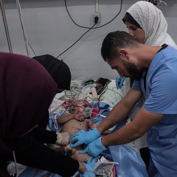 Staff at al-Shifa Hospital treat a Palestinian infant wounded in an Israeli airstrike