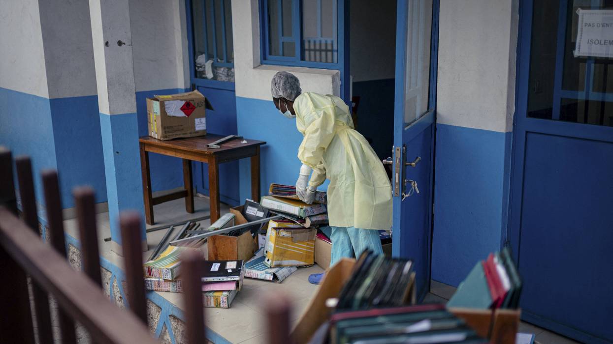 Staff members at CBCA Virunga Hospital prepare rooms intended for possible suspected Ebola cases