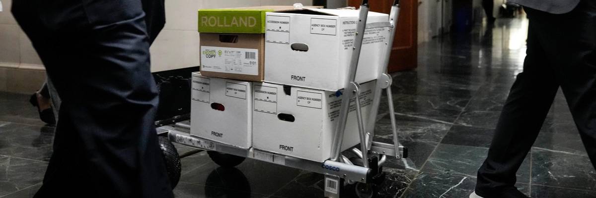 Staffers move boxes of documents from a hearing room to the office of the House Ways and Means Committee