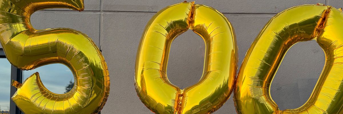 Starbucks workers hold "500" balloons