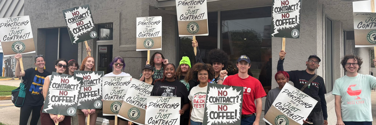 Starbucks workers hold signs reading "No contract? No coffee!"