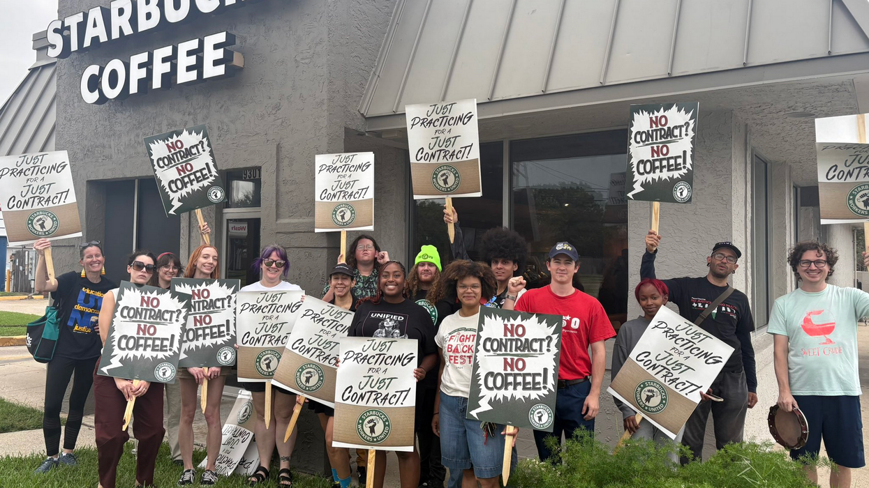 Starbucks workers hold signs reading "No contract? No coffee!"