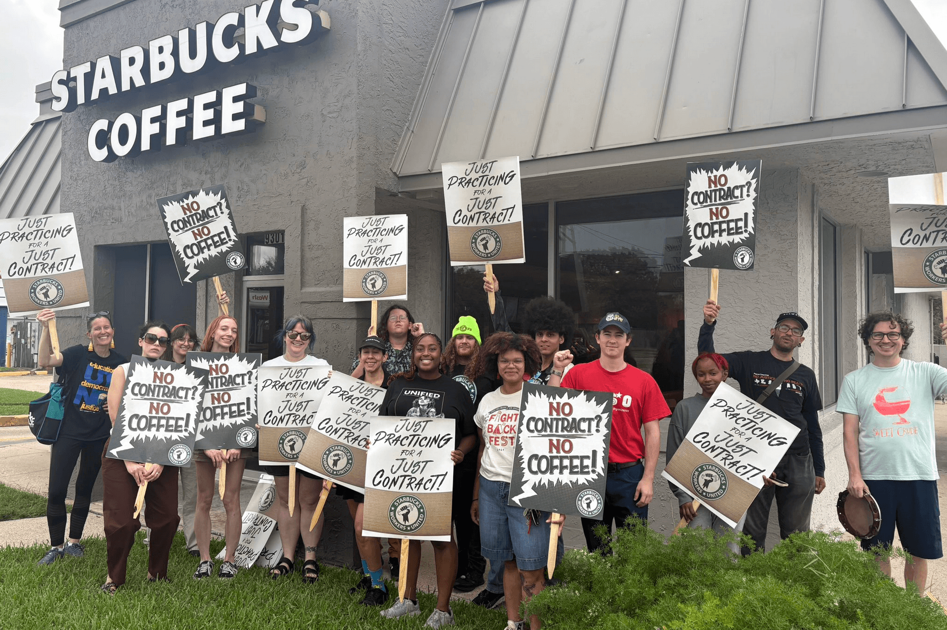 Starbucks workers hold signs reading "No contract? No coffee!"