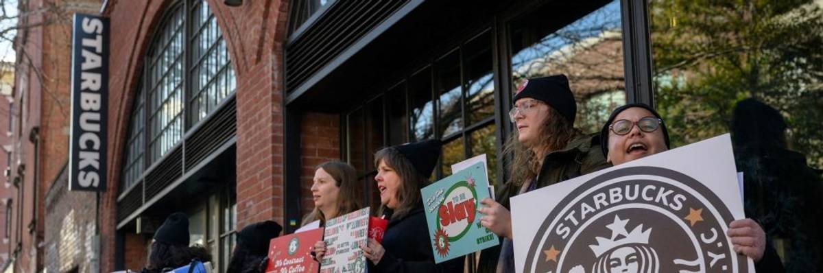 Starbucks workers strike outside a Starbucks coffee shop