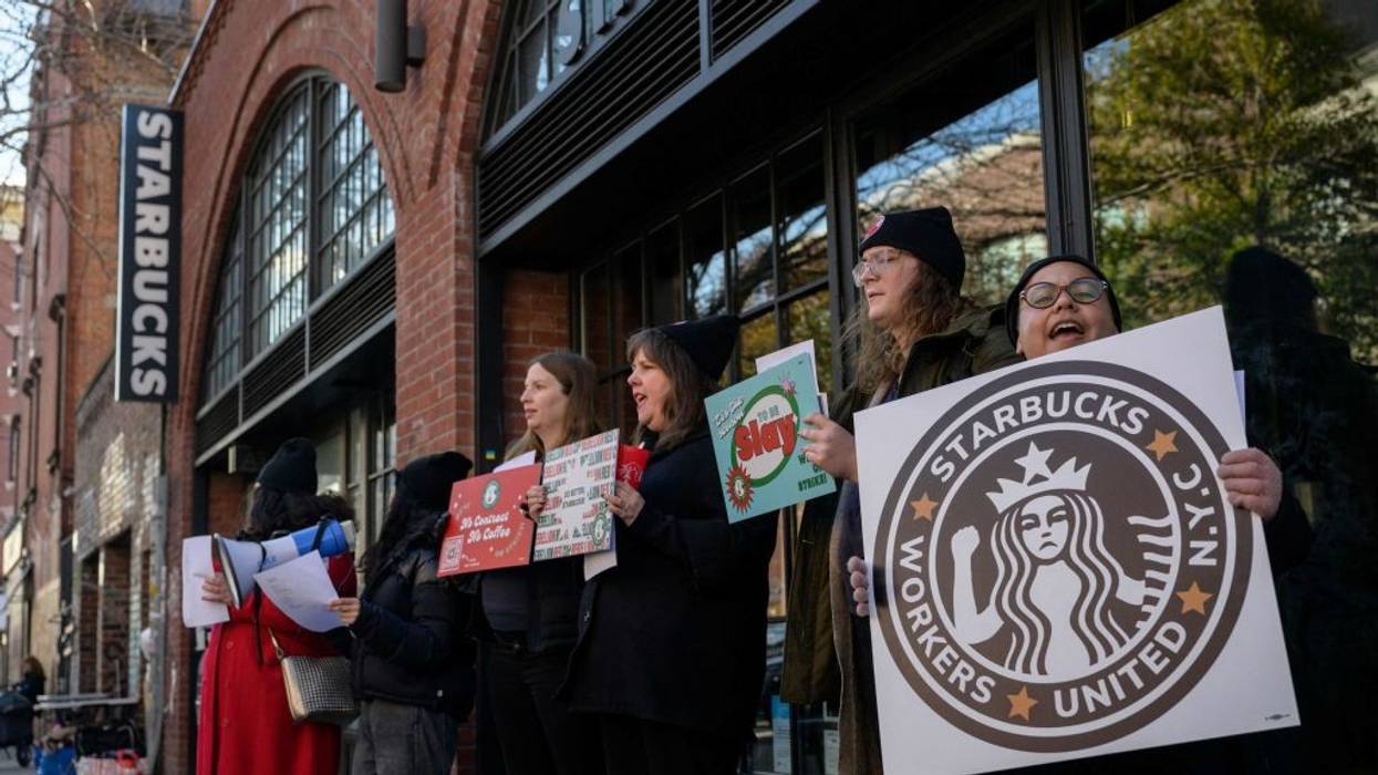 Starbucks workers strike outside a Starbucks coffee shop