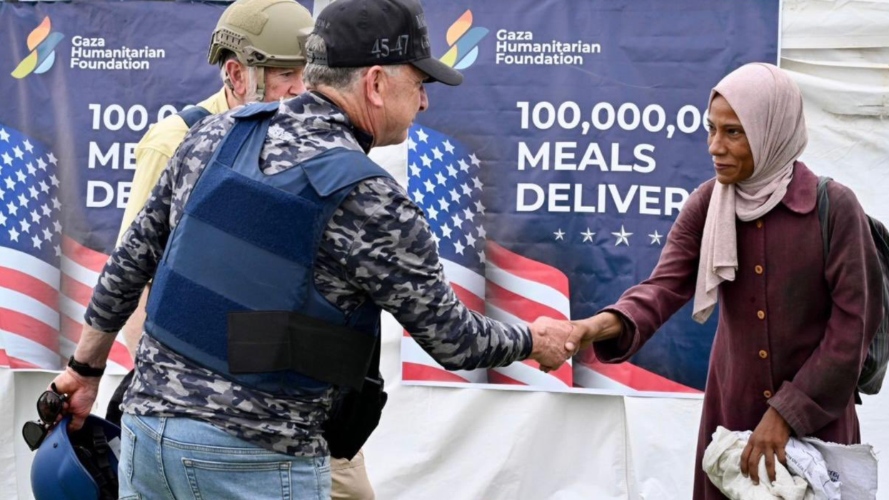 Steve Witkoff shakes hands with a Palestinian woman at an aid center