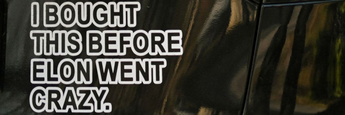 Sticker on Tesla says: "I Bought this Befoer Elon Went Crazy"