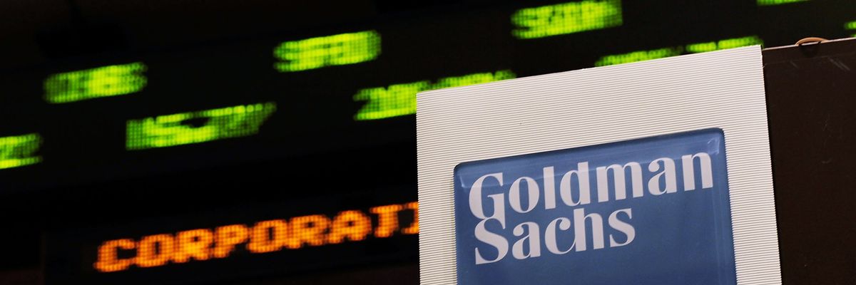 Stock prices whiz by on a ticker near the Goldman Sachs booth