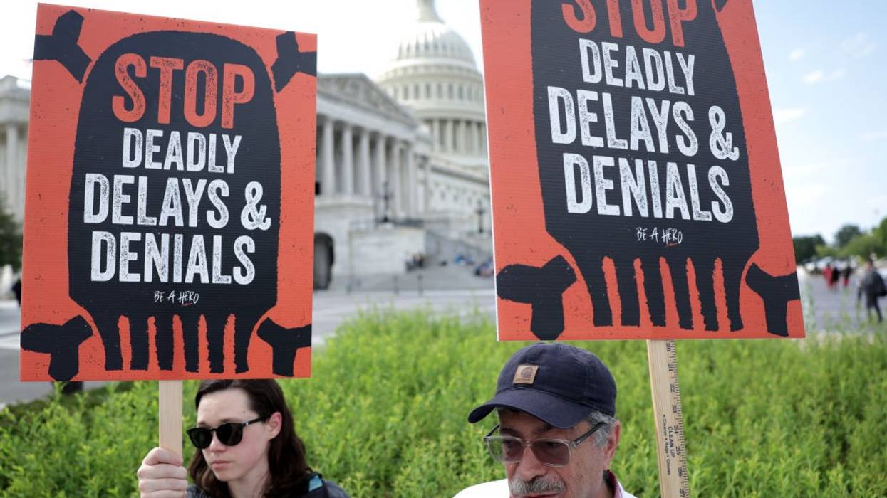 "Stop Deadly Delays and Denials" signs say