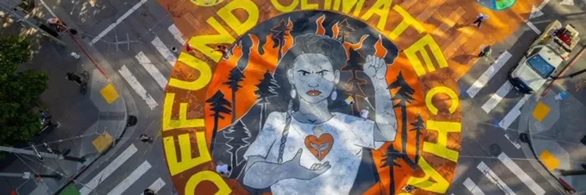 Street art painted in Northern California in 2021 themed around the demand to 'Defund Climate Chaos.'​